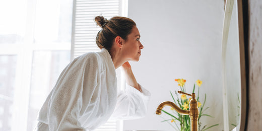woman looking in the mirror in the morning