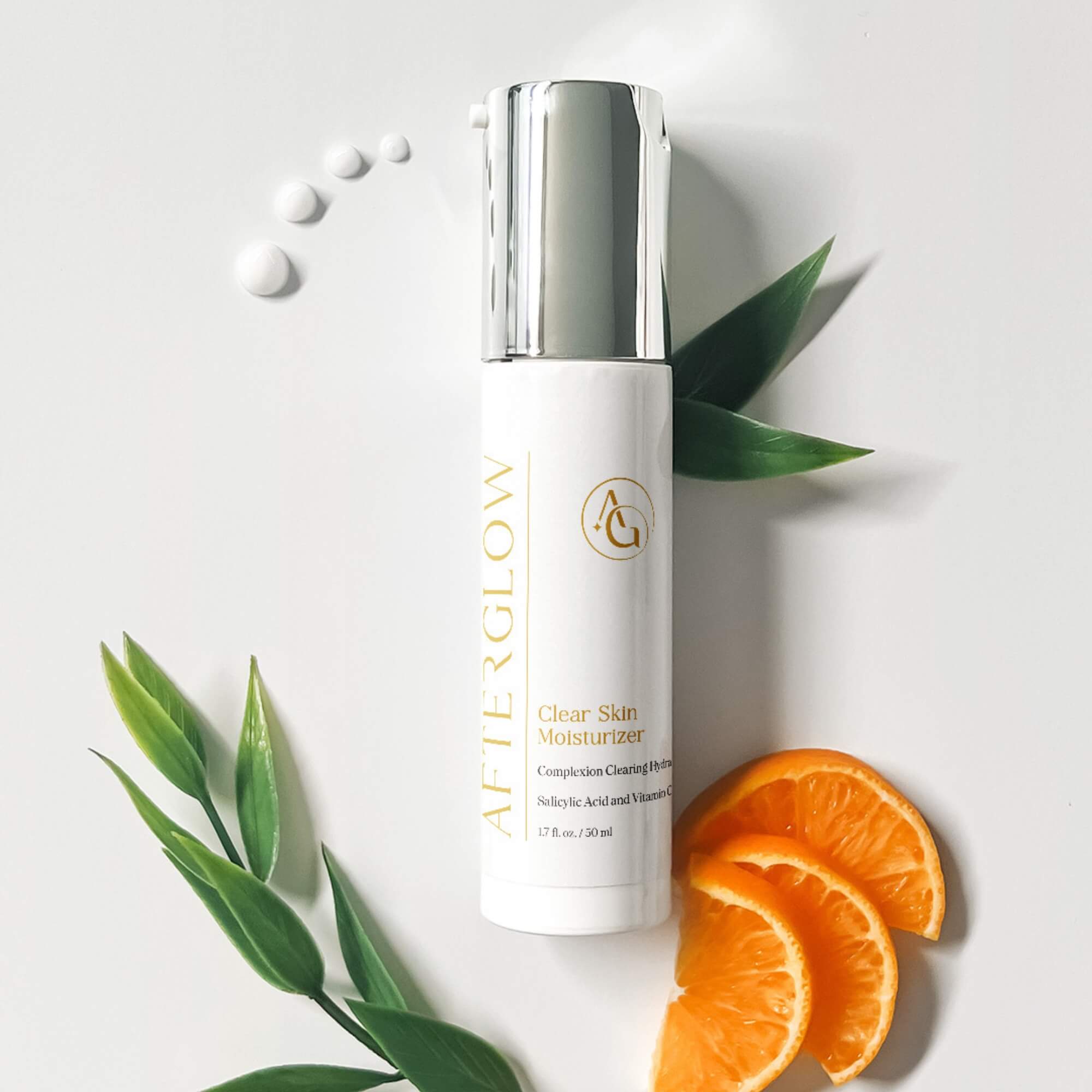 Afterglow Skin Co. Clear Skin Moisturizer with orange slices and leaves on a light background