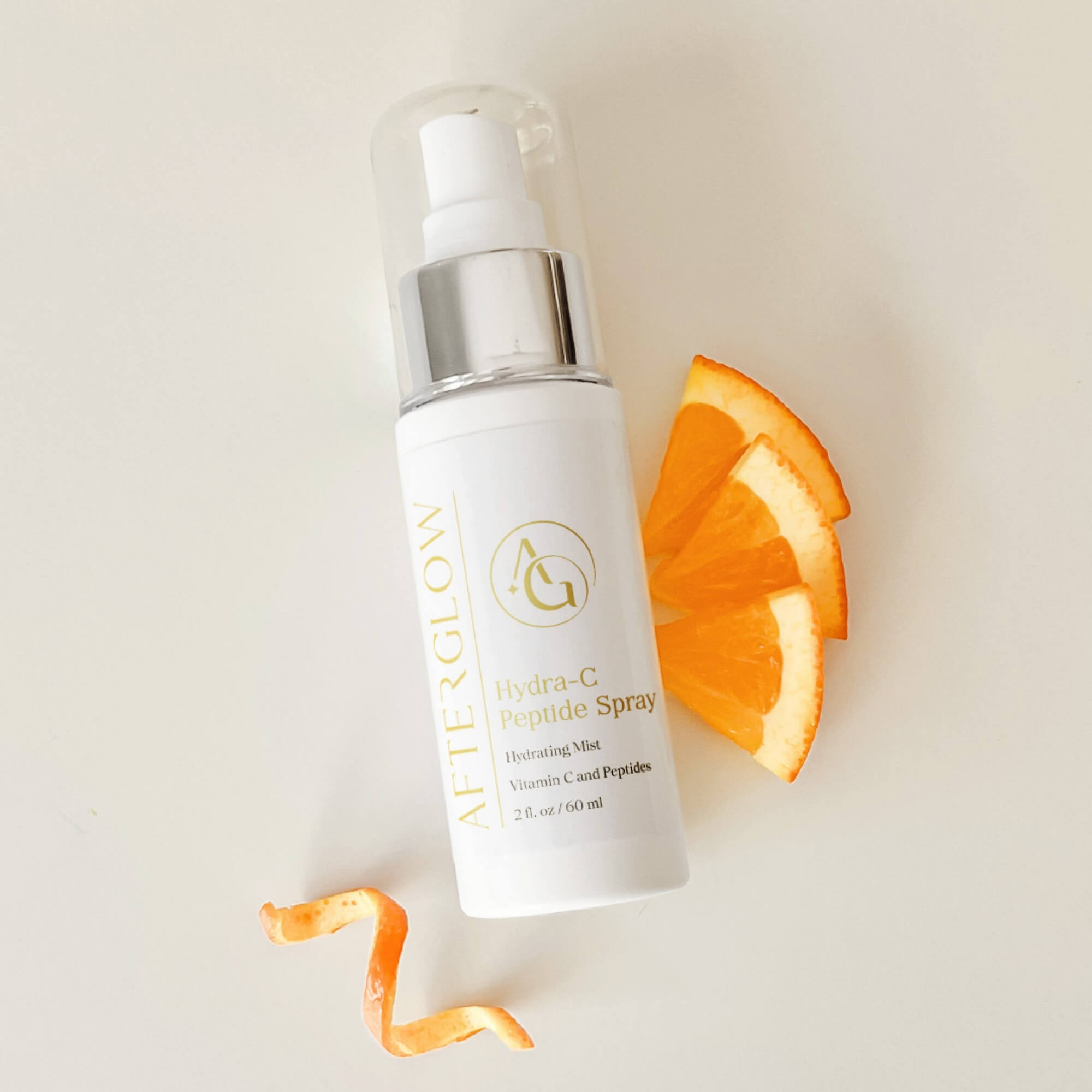 Afterglow Skin Co Bottle with orange slices on a light background