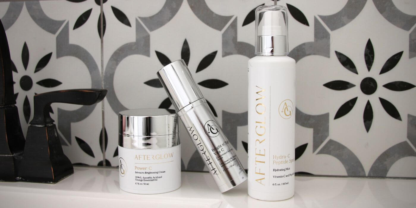 Three Afterglow Skin co. products on bathroom sink counter with tile background